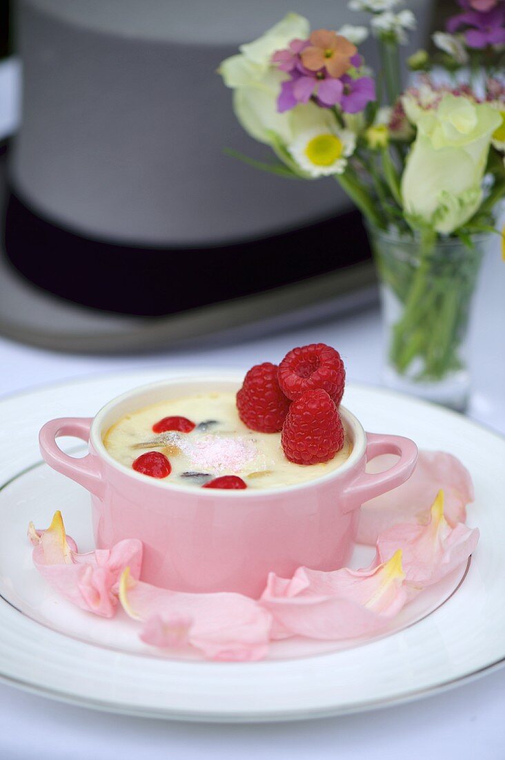 Creamy dessert with raspberry purée and fresh raspberries