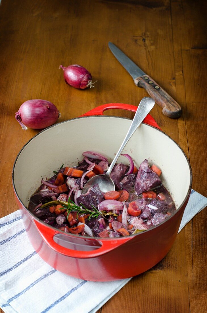 Beef being marinated in red wine to make boeuf bourguignon