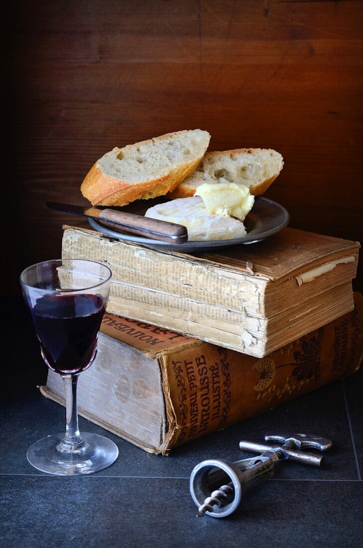 An arrangement of cheese, bread and red wine