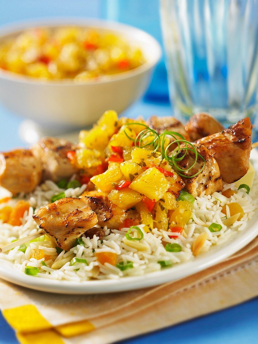 Rice with chicken skewers and pineapple and mint chutney