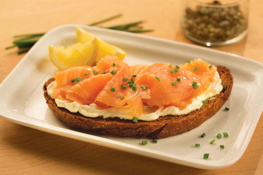 A slice of wholemeal bread topped with cream cheese and smoked salmon