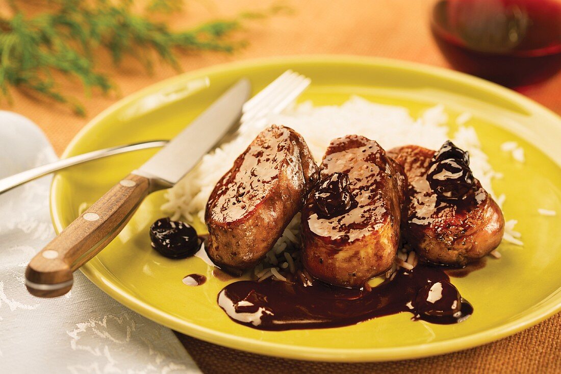 Pork medallions with a cherry and pomegranate sauce and rice