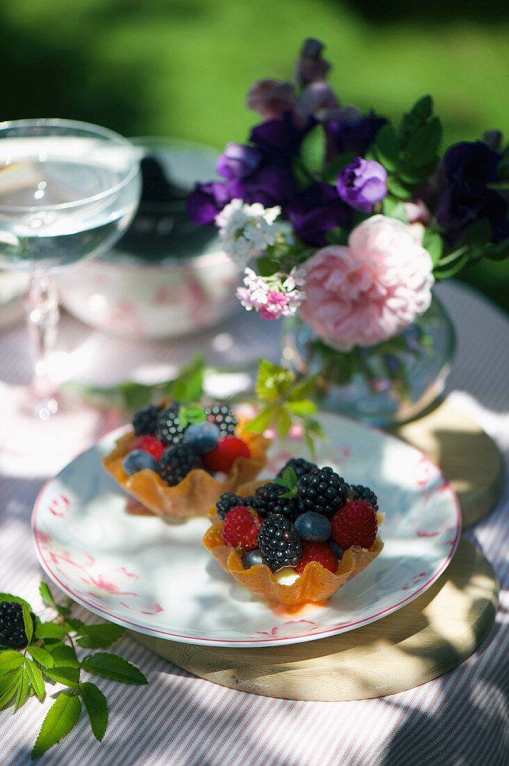 Mini lemon tartlets with mixed summer berries