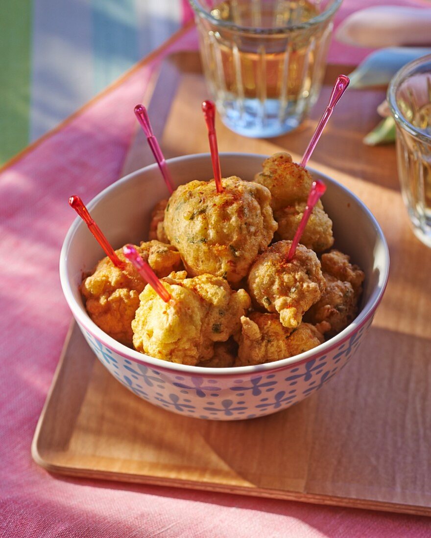 Crab balls with cocktail sticks in a bowl
