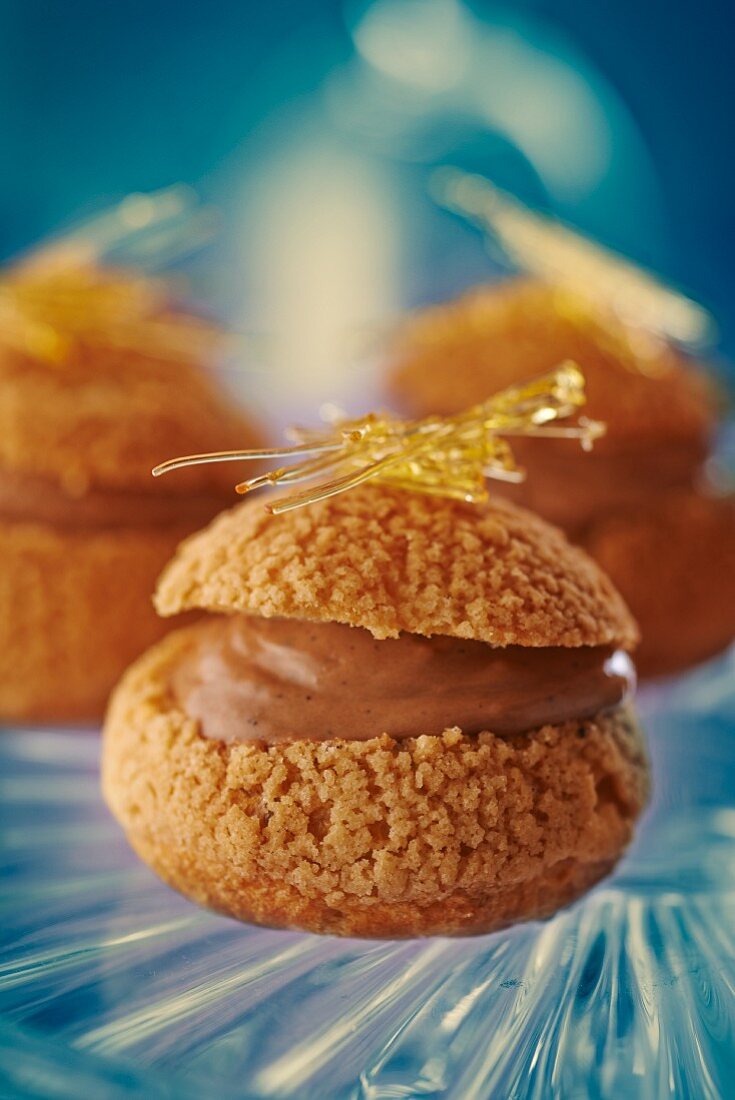 Profiteroles filled with chocolate cream topped with caramel threads