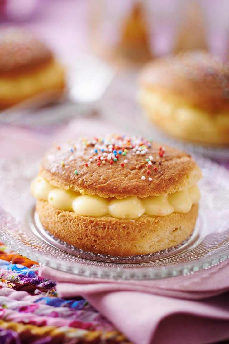 A mini Tarte Tropezienne with colourful sugar sprinkles (France)