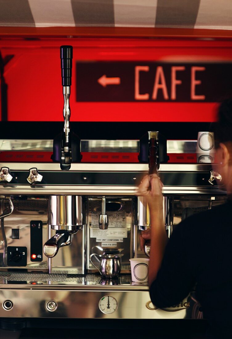 A mobile espresso bar: a person operating the espresso machine