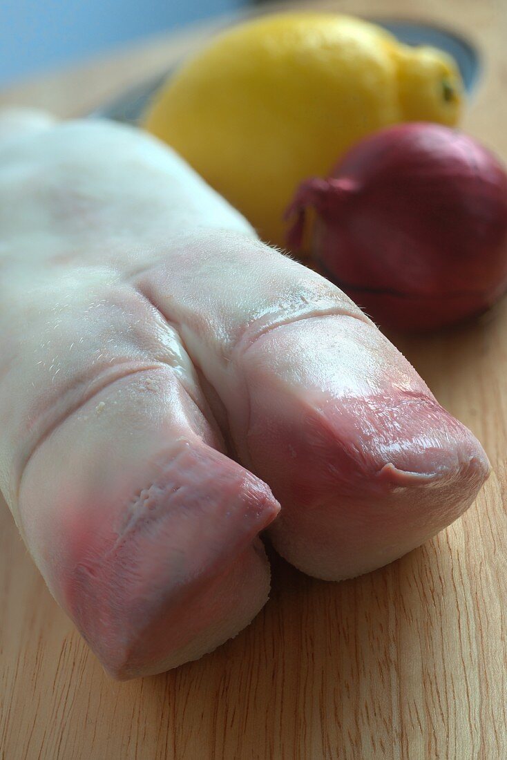 A fresh calf's foot, an onion and a lemon