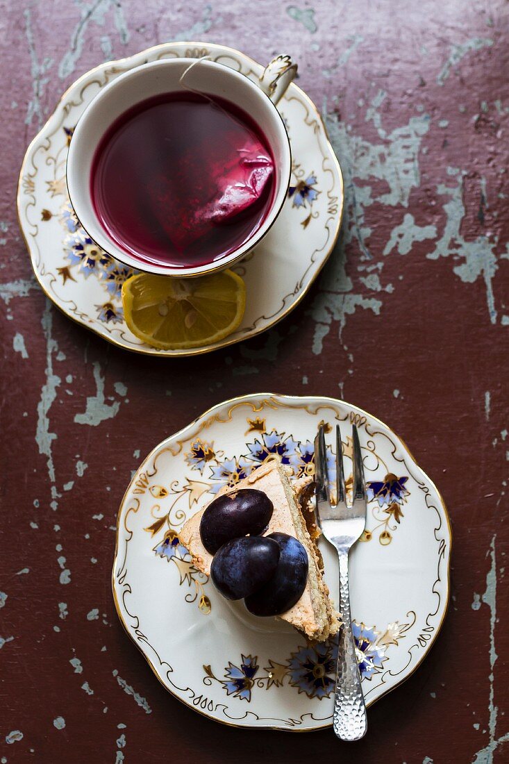 A cup of fruit tea and a slice of plum cake