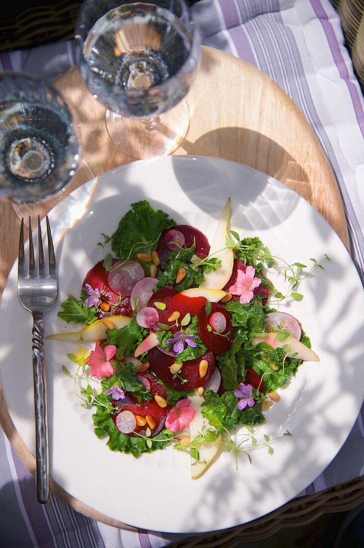 Beetroot and green kale salad with radishes, pears and flowers