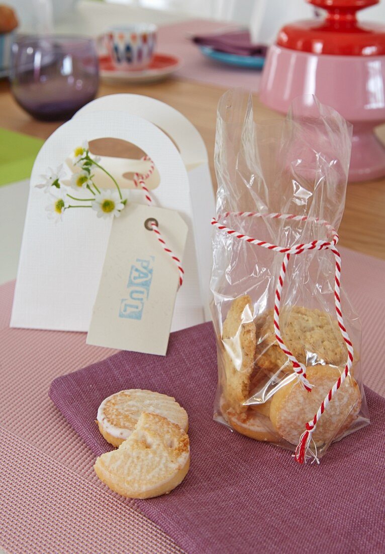 Lemon biscuits in a cellophane bag with a ribbon on a purple place mat