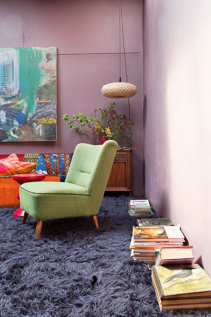 Long-pile carpet and flea-market furnishings in living room with purple walls