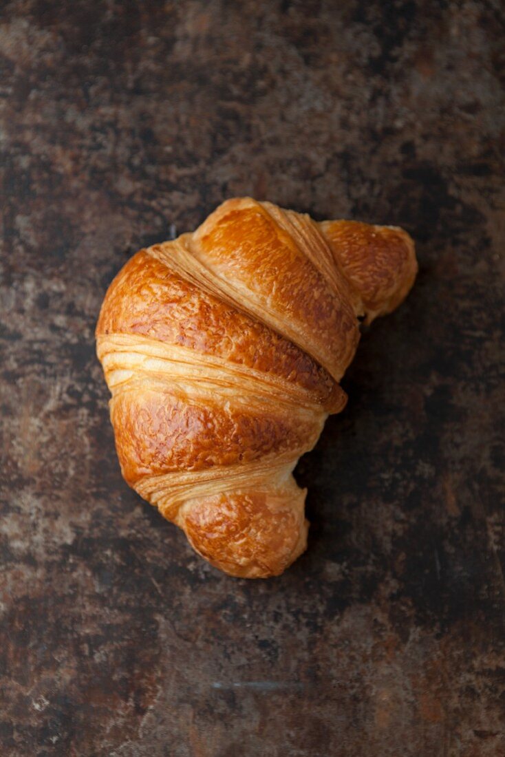 A croissant on a baking tray