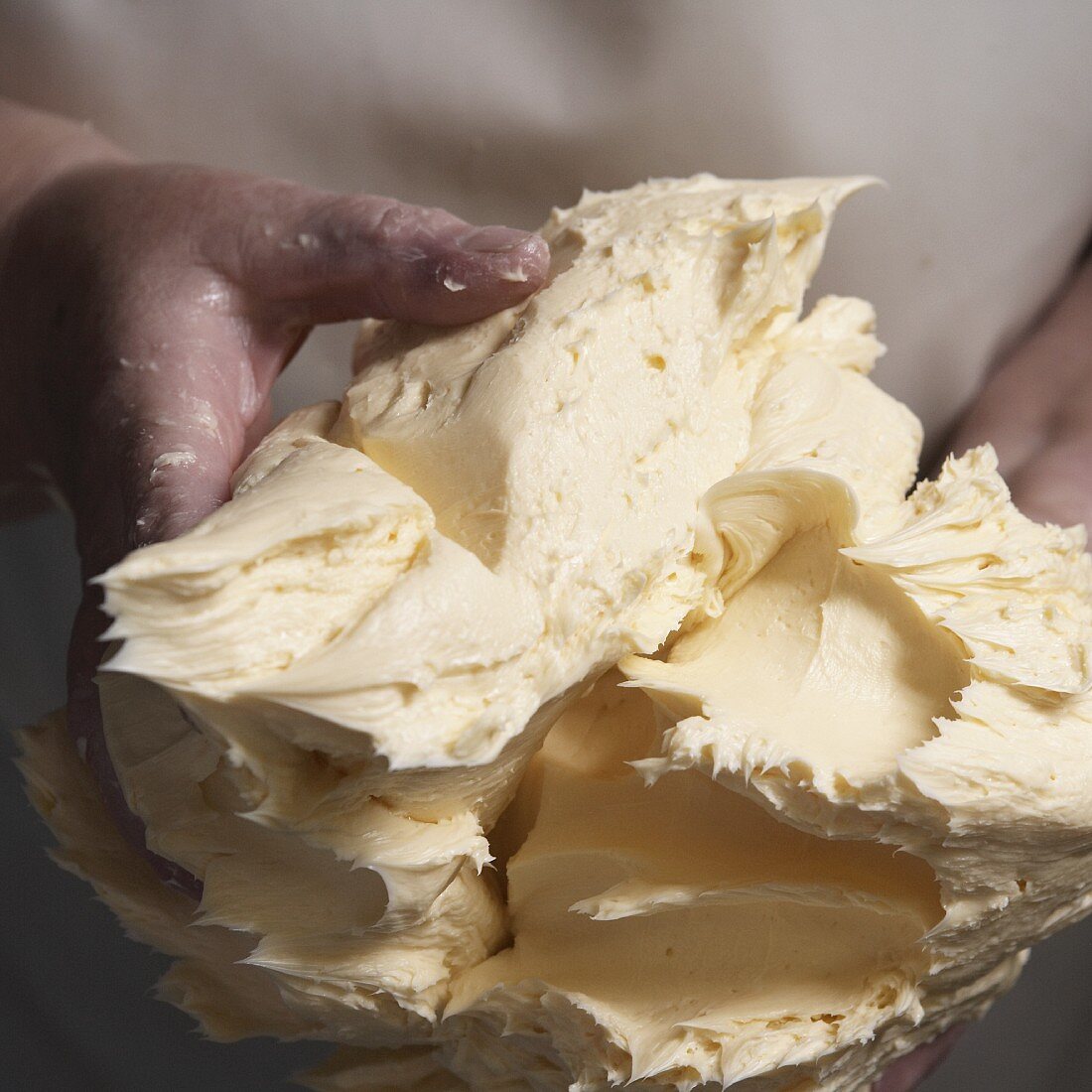 Hands holding freshly made butter