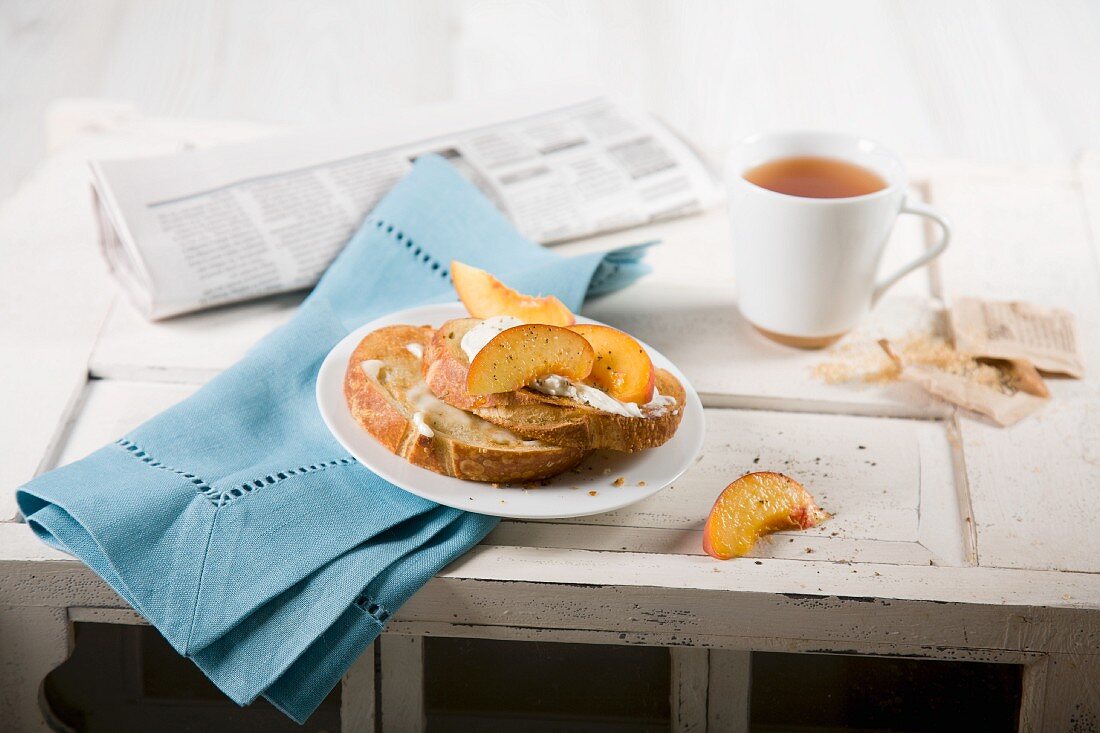 Breakfast with toast, peaches and a cup of tea