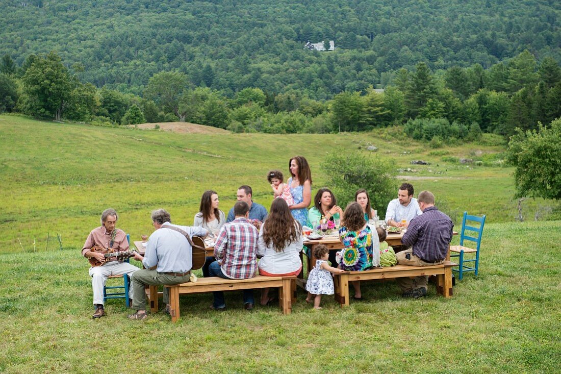 Family eating meal together outdoors