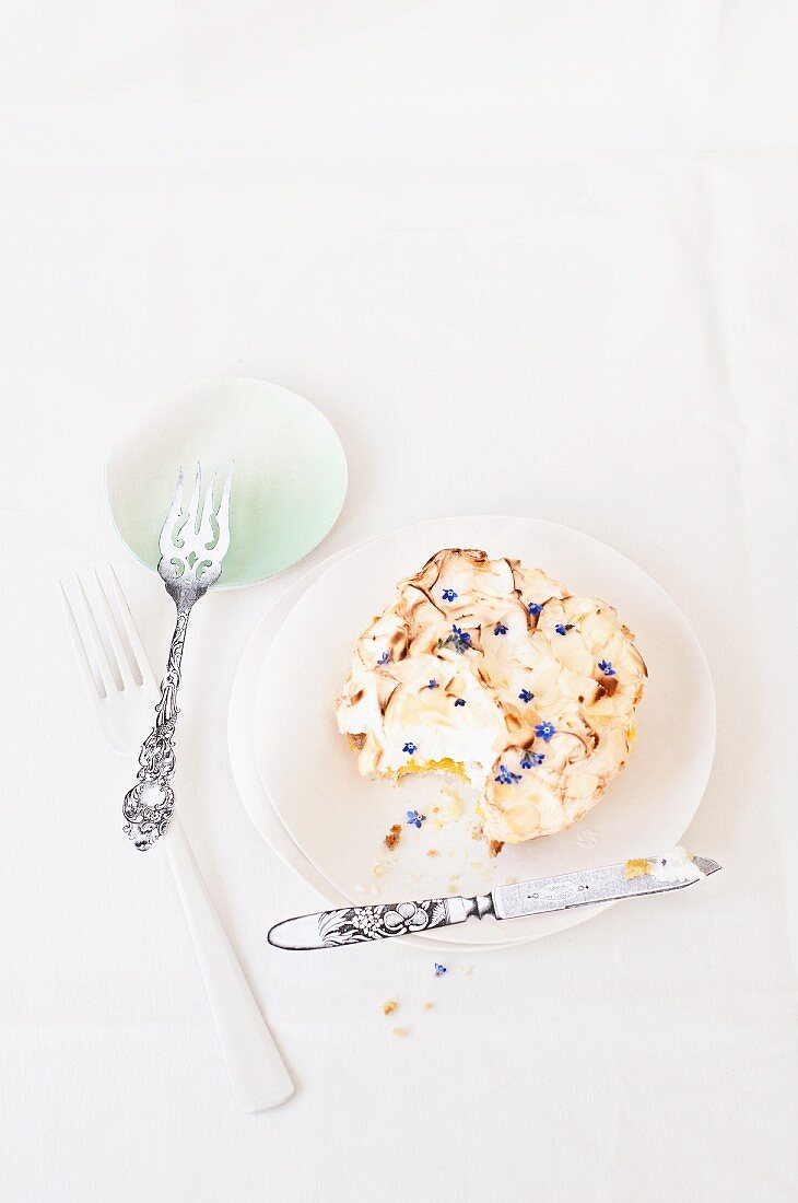 Lemon cake scattered with forget-me-not florets