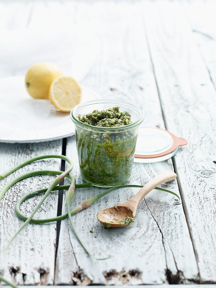 Salsa verde in a glass on a wooden table