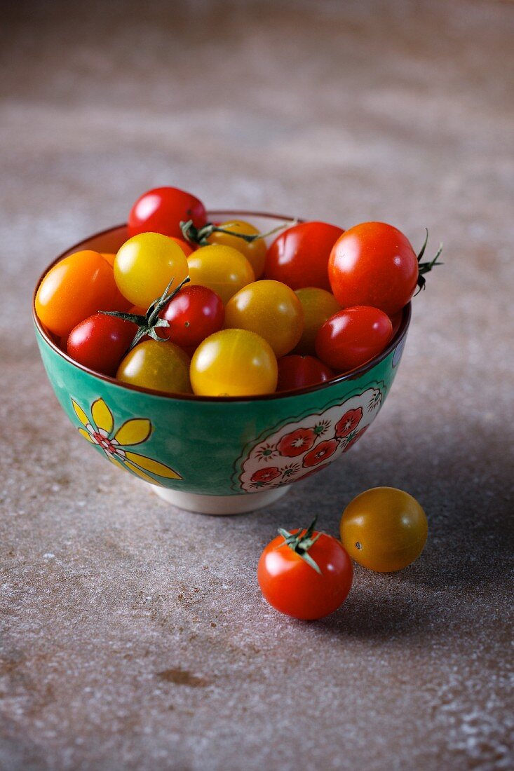 Red and yellow cherry tomatoes in a bowl