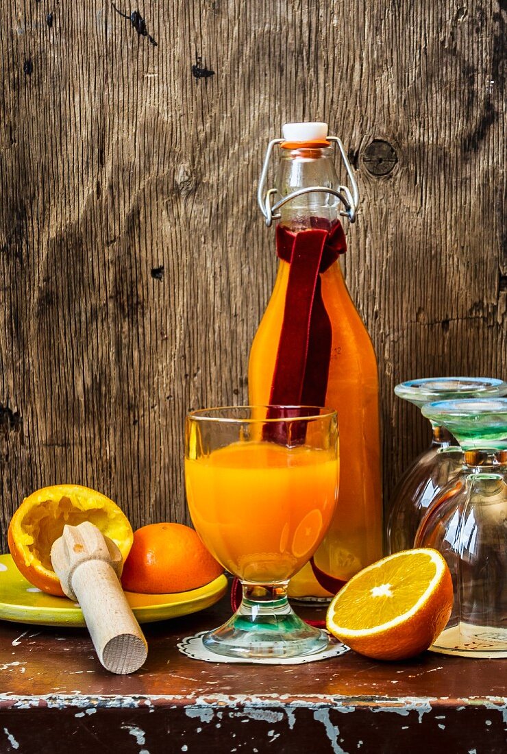 Orange juice in a glass and in a bottle