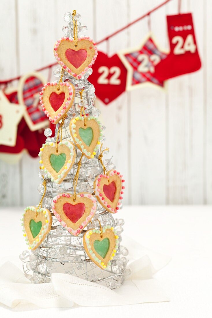 Shortbread hearts with sugar windows hung on a glass Christmas tree