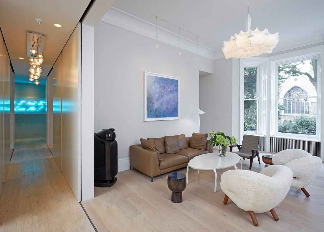 Private Apartment, London, United Kingdom. Architect: Hill Mitchell Berry, 2014. Open-plan living room with extravagant armchairs and white coffee table