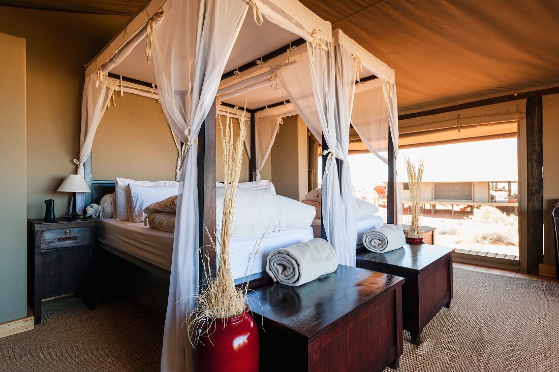 An elegant bedroom in 'Dune Camp' in Wolwedans, NamibRand Nature Reserve, Namibia, Africa