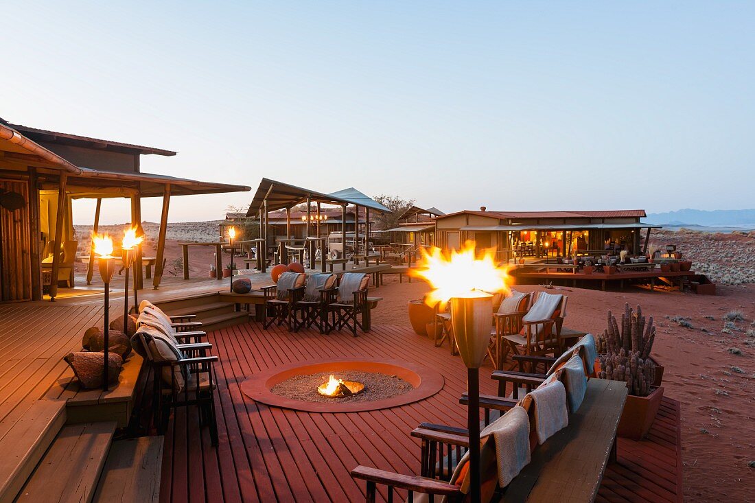 Wolwedans, NamibRand Nature Reserve, Namibia, Africa - 'Dunes Lodge' with torches and a fire pit in the evening