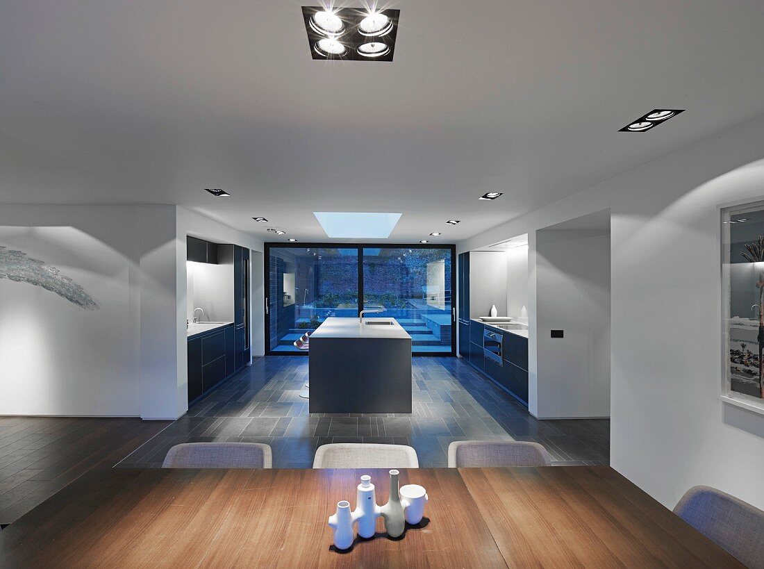 Point 7, Winchester, United Kingdom. Architect: Dan Brill Architects, 2014. View across dining table into kitchen area and to terrace windows