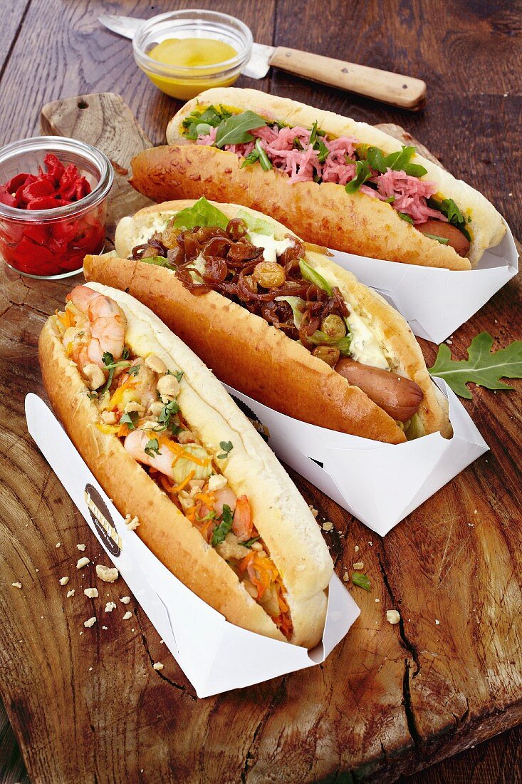 Three different hot dogs (classic, Thai and cheese)
