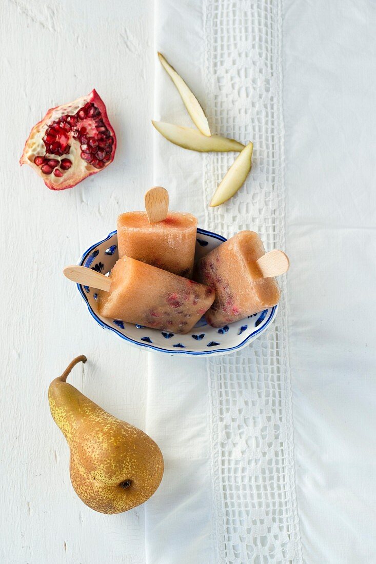 Pear ice lollies with pomegranate seeds