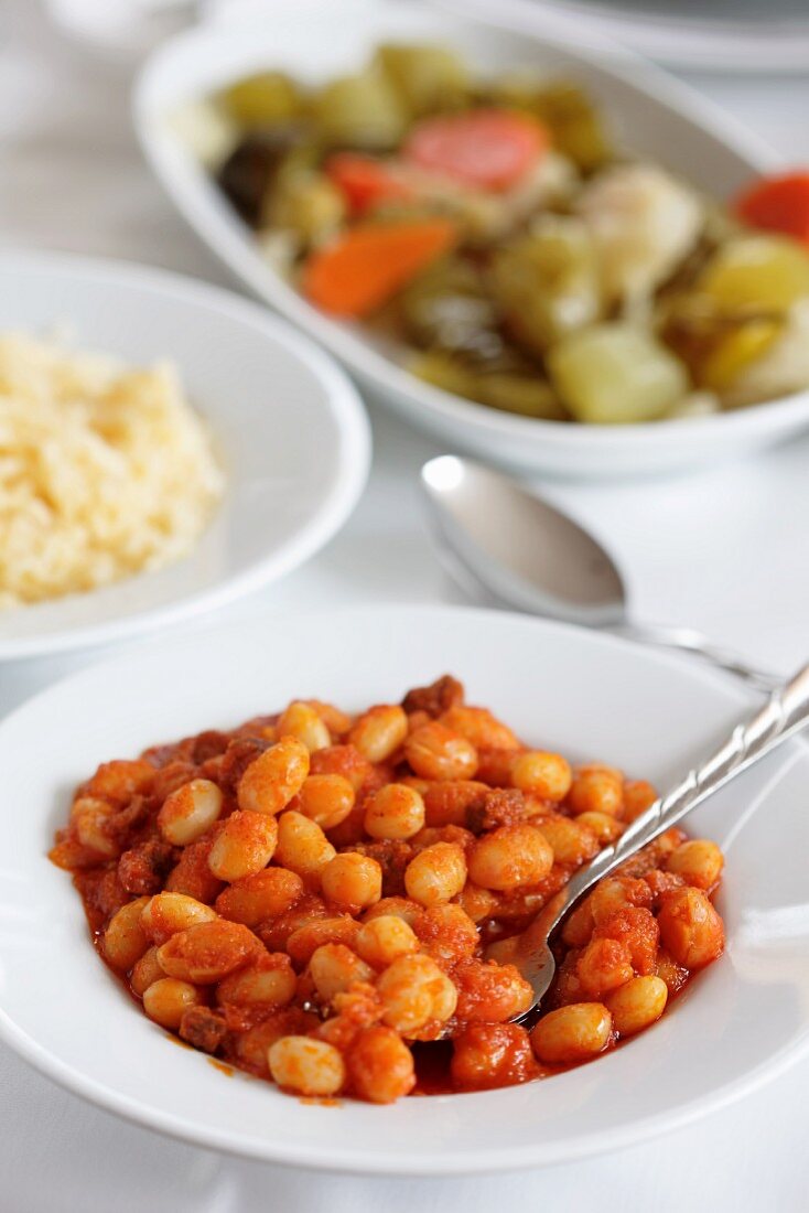 Dried beans in tomato sauce with rice and pickles (Turkey)