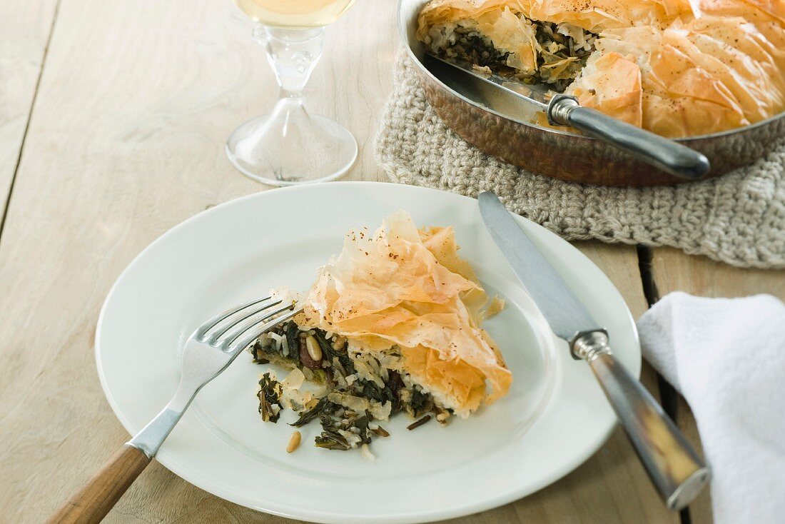 Vegetarian pie with wild rice, spinach, pine nuts and raisins