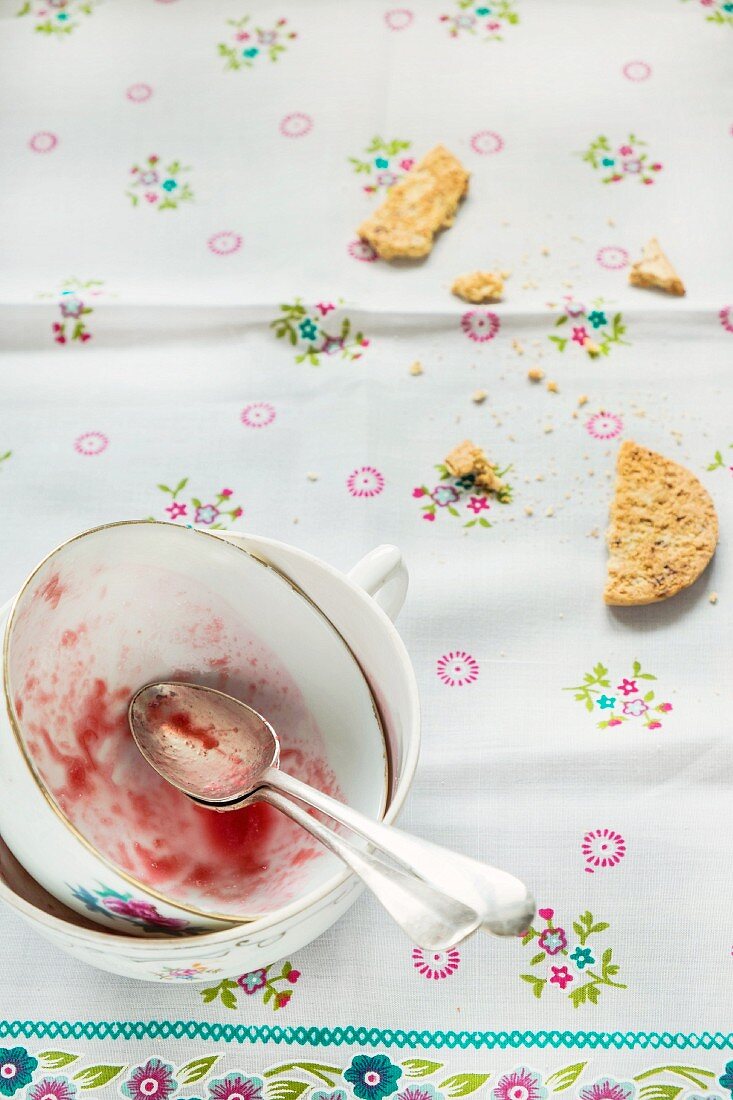 The remains of rhubarb and strawberry compote in a cup