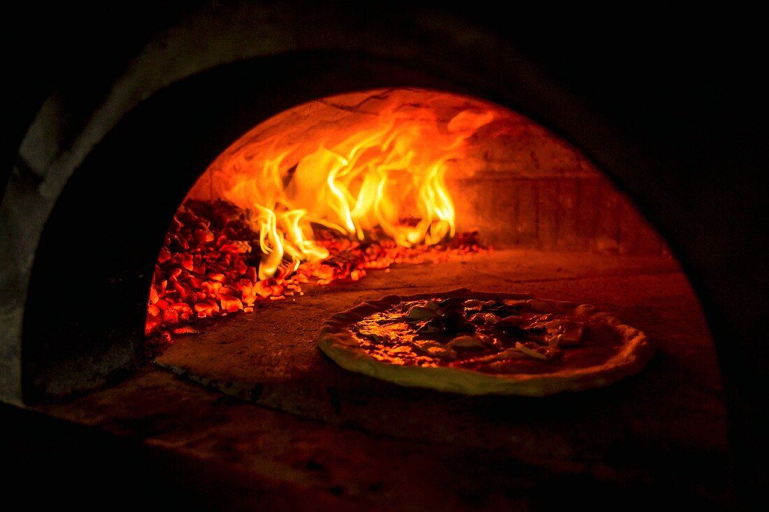 A Pizza Margerita in a wood-fired oven