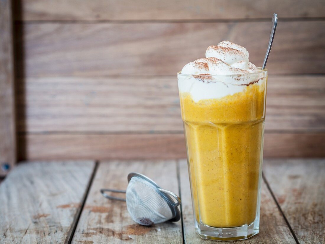 A pumpkin spice smoothie with whipped cream