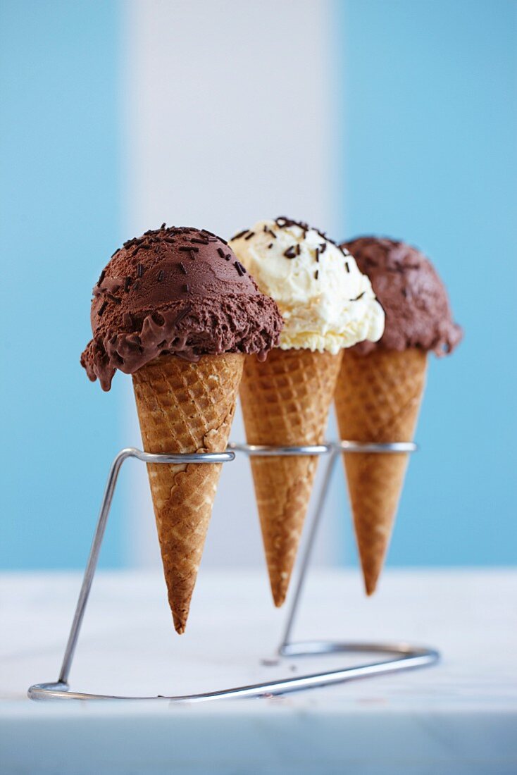 Three ice cream cones with chocolate sprinkles