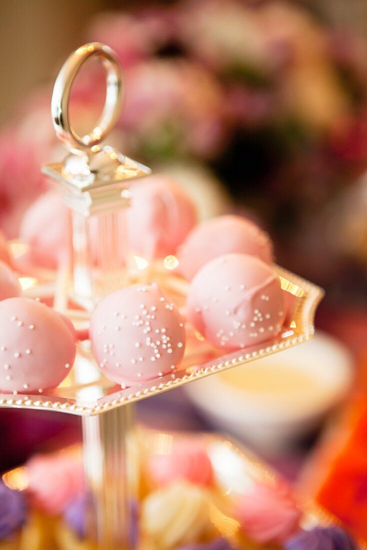Pink pralines on a golden stand