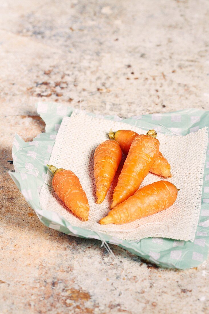 Baby carrots on a piece of paper
