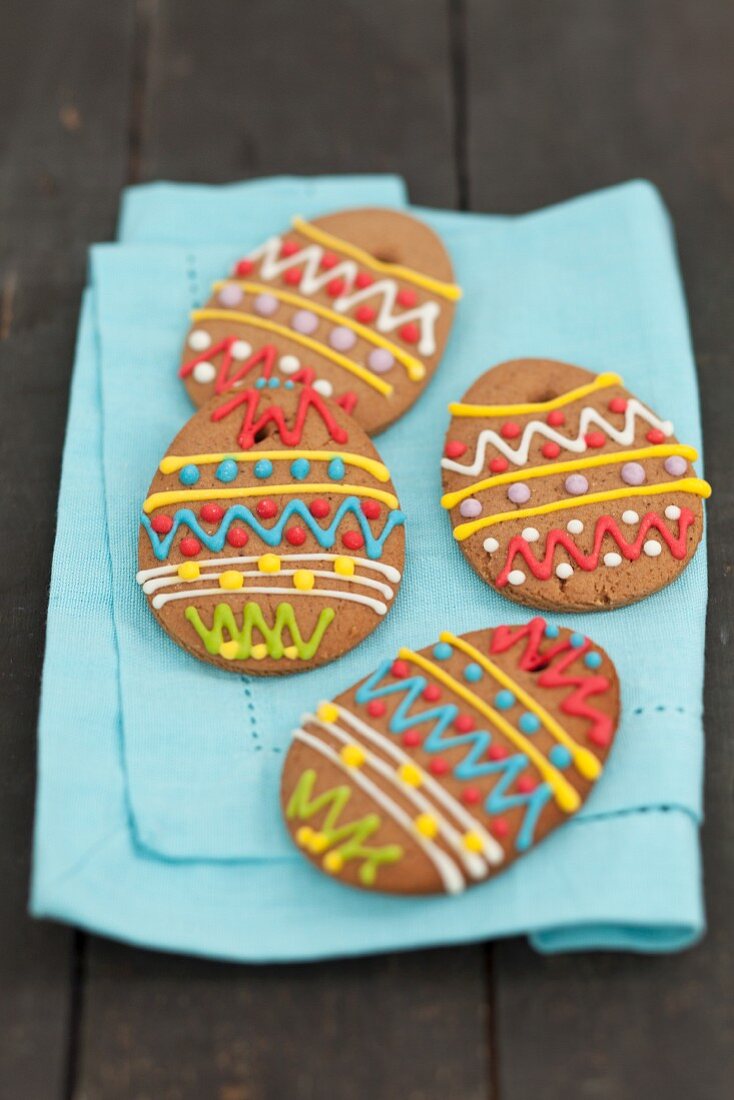 Decorated gingerbread eggs on a fabric napkin