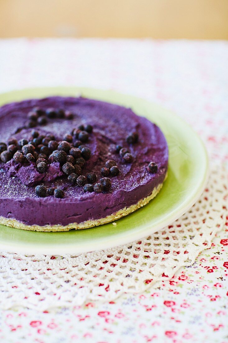 A nut-free cheesecake with a date and coconut base and a blueberry and sunflower seed topping