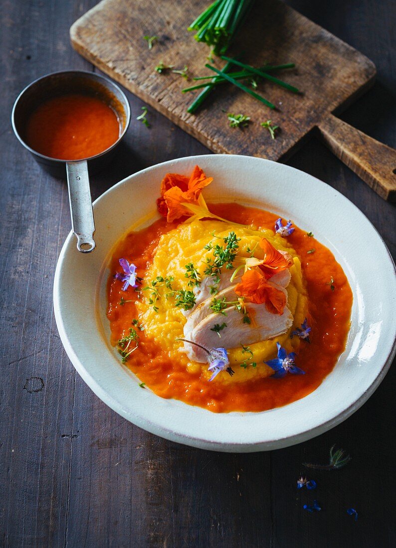 Vegetable puree with edible flowers and turkey breast