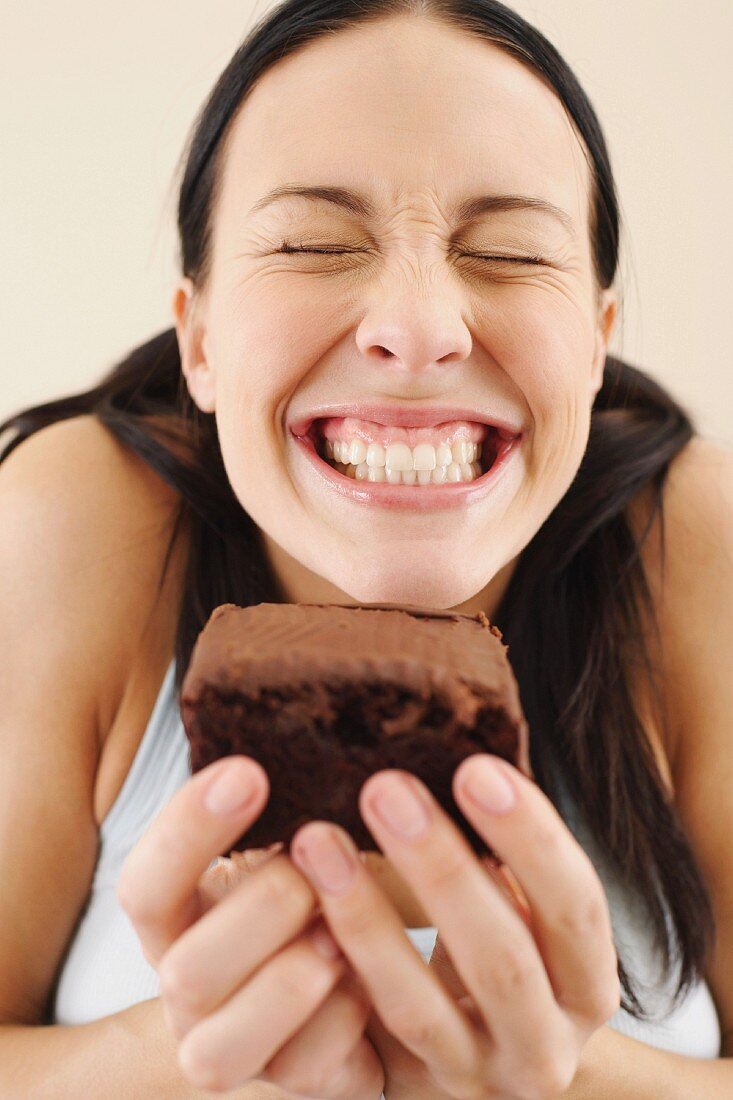 A woman holding a slice of cake