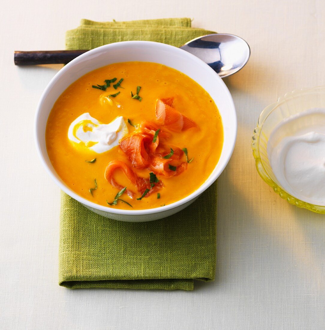 Pumpkin curry soup with smoked salmon and sour cream