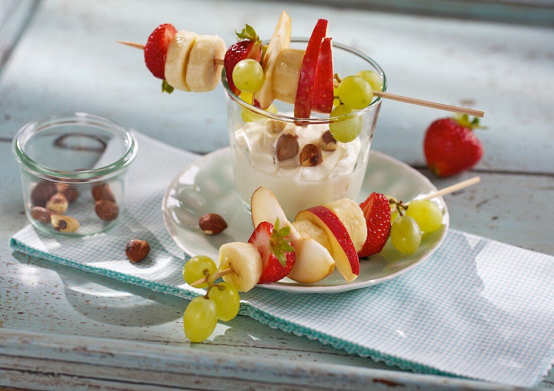 Fruit skewers with a lemon dip and hazelnuts