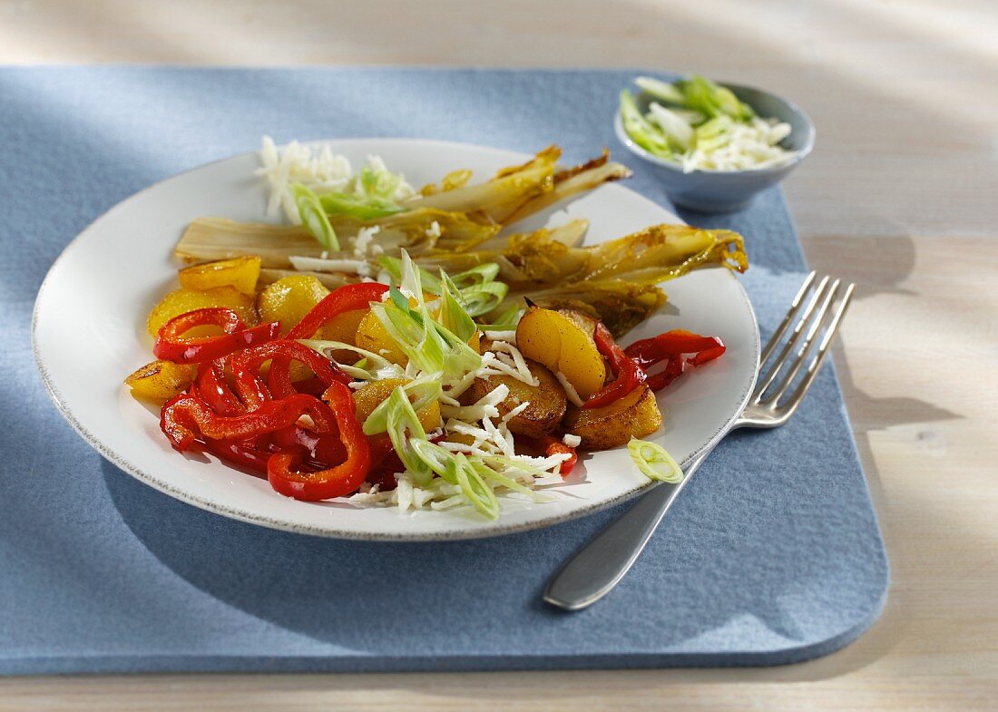 Fried potatoes with caramelised chicory, red peppers and spring onions