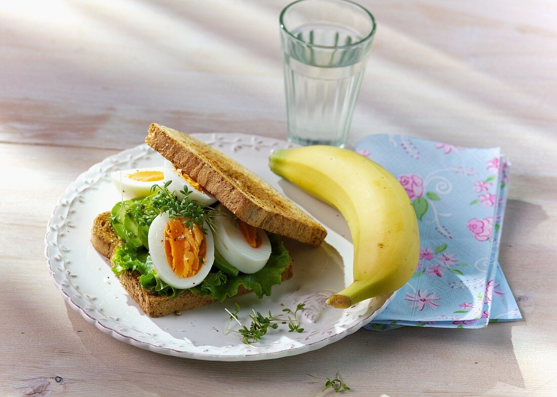 An egg sandwich with pesto and avocado