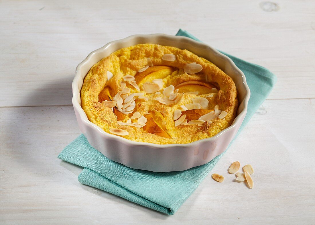 Peach and polenta bake with banana and flaked almonds