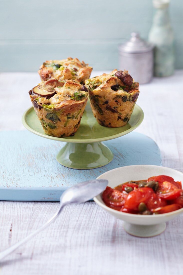 Mushroom dumpling muffins with spring onions served with a tomato sauce with capers