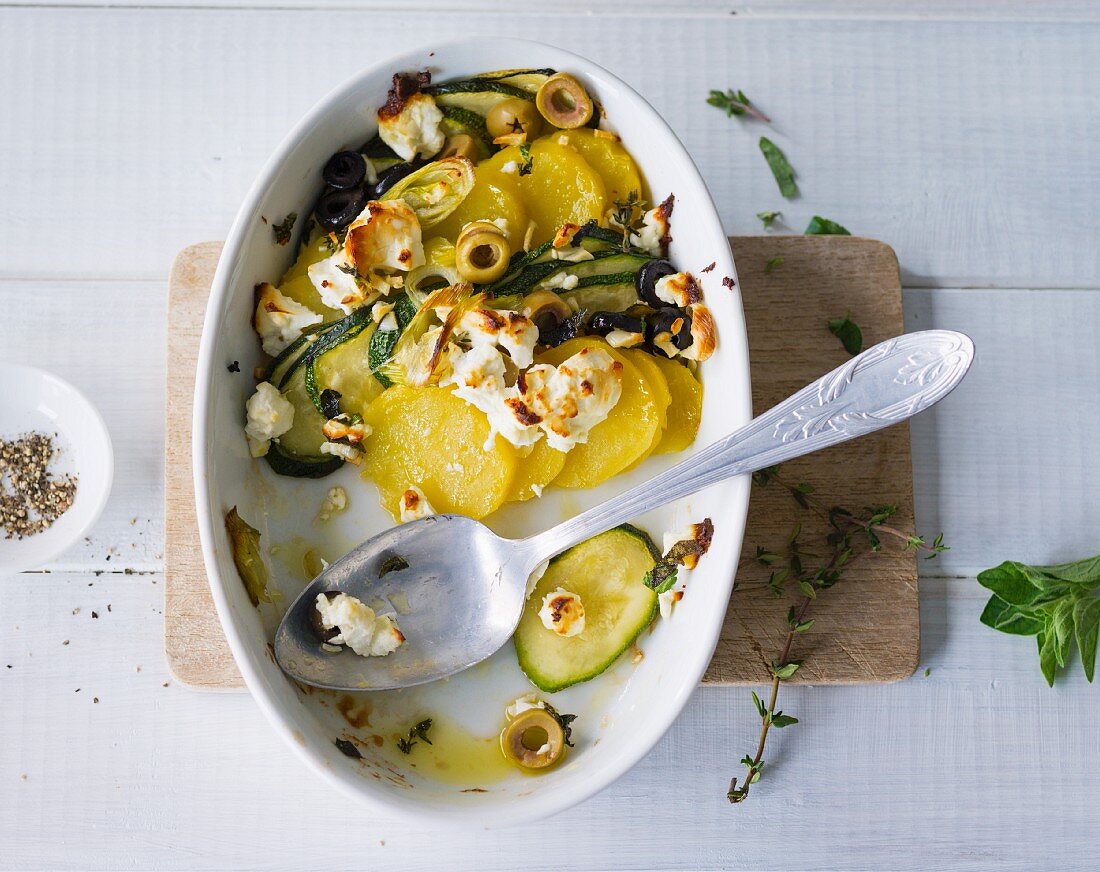 Courgette and potato gratin with sheep's cheese and green olives